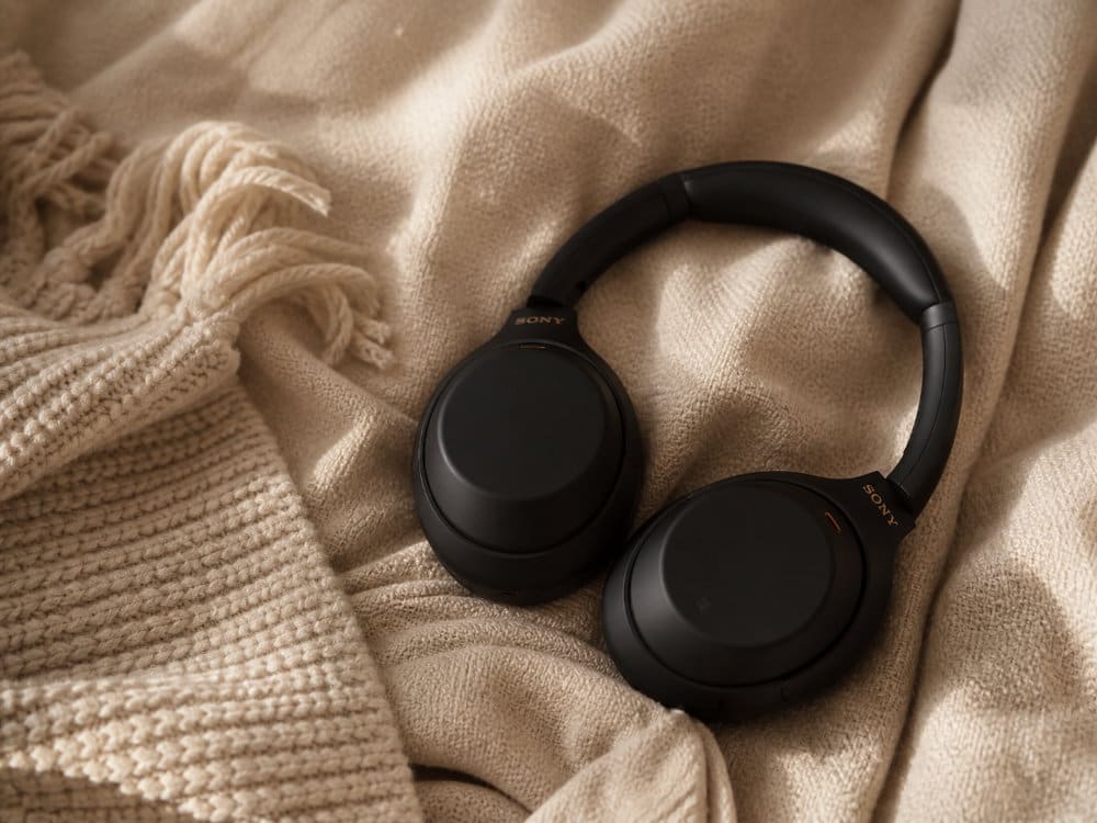 Noise-cancelling headphones on a soft blanket — comfort amenities at Yūgen Dental in Sandton